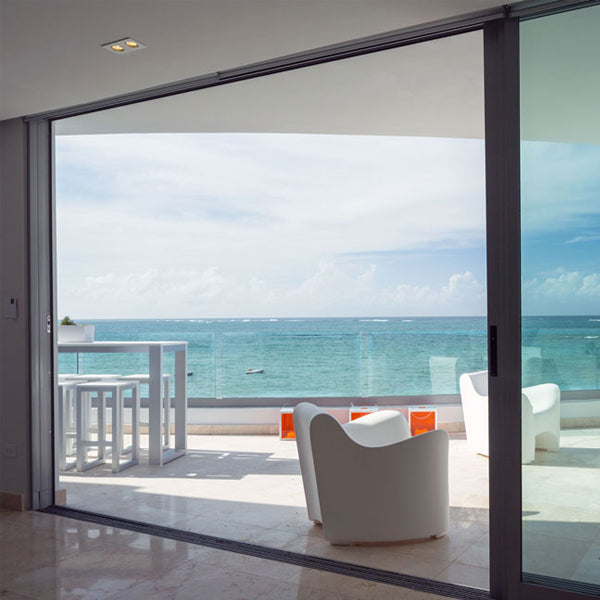 view of ocean through sliding glass door impact resistant