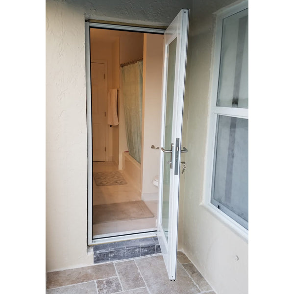 single french impact resistant door opening from bathroom to patio in Miami home