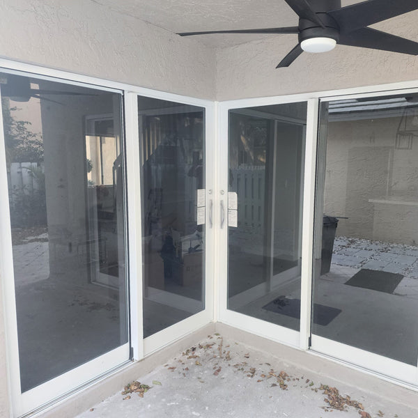 2 patio sliding glass impact doors meeting in corner of terrace